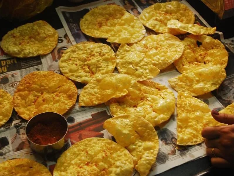 Freshly made papad being prepared by hand